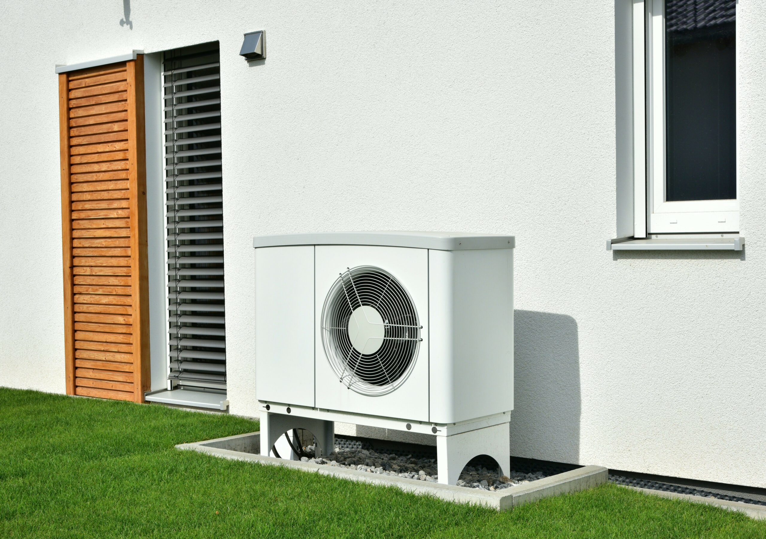 air source heat pump installed in back garden of property